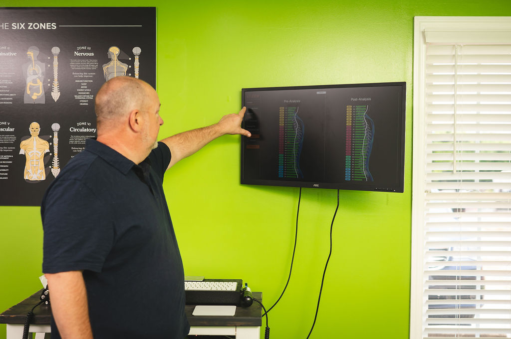 Dr. Mike Geran reviewing spinal analysis results in the Foothills Chiropractic office