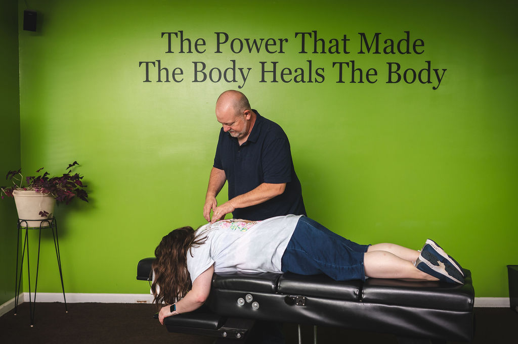 Dr. Mike Geran performing an evaluation in the Foothills Chiropractic treatment room
